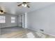 Cozy bedroom with a ceiling fan, built-in shelving, and ample natural light from two windows at 1355 Compton Woods Dr, Loganville, GA 30052