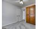 Bedroom with neutral carpet and walls, ceiling fan, double door closets, and a wood cabinet at 1355 Compton Woods Dr, Loganville, GA 30052