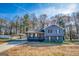 Two-story home featuring a carport, a welcoming front porch, and tasteful landscaping at 1355 Compton Woods Dr, Loganville, GA 30052
