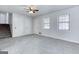 Spacious living area with new carpeting, two closets, a ceiling fan, and a large door at 1355 Compton Woods Dr, Loganville, GA 30052