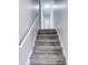 Carpeted stairway with white handrail leading to the upper level of the home at 1355 Compton Woods Dr, Loganville, GA 30052