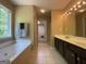 Relaxing bathroom featuring a soaking tub, large window, and a double vanity at 616 Wallnut Hall Tl, Woodstock, GA 30189