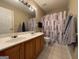 Bathroom features a shower/tub combination, white toilet, and a double sink vanity at 616 Wallnut Hall Tl, Woodstock, GA 30189