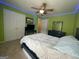 Bedroom with green walls and ceiling fan, includes queen bed, dresser, and closet at 616 Wallnut Hall Tl, Woodstock, GA 30189
