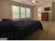 Bright bedroom with large windows, neutral walls, a TV, and a spacious layout at 616 Wallnut Hall Tl, Woodstock, GA 30189
