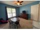 Comfortable bedroom with window and curtains; features a table, chairs and mounted television at 616 Wallnut Hall Tl, Woodstock, GA 30189