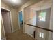 Upstairs hallway features hardwood floor, white railing and two open doorways at 616 Wallnut Hall Tl, Woodstock, GA 30189