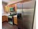 A kitchen featuring stainless steel appliances, hardwood floors, a range hood, and white counters at 616 Wallnut Hall Tl, Woodstock, GA 30189
