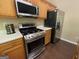 A kitchen featuring stainless steel appliances, oak cabinets, white counters, and a gas range stove at 616 Wallnut Hall Tl, Woodstock, GA 30189
