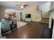 Bright living room featuring hardwood floors, fireplace, and seamless access to the kitchen and staircase at 616 Wallnut Hall Tl, Woodstock, GA 30189