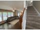 Open-concept living room that blends natural light with hardwood floors and smooth access to the stairwell at 616 Wallnut Hall Tl, Woodstock, GA 30189
