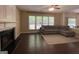 Cozy living room featuring a fireplace, hardwood flooring, and natural light from multiple windows at 616 Wallnut Hall Tl, Woodstock, GA 30189