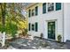 Charming exterior of a white house with dark green shutters and door, complemented by well-maintained landscaping at 1664 W Wesley Nw Rd, Atlanta, GA 30327