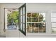 A door leads to an outdoor patio featuring a seating arrangement, greenery and sunlight streaming in at 1664 W Wesley Nw Rd, Atlanta, GA 30327