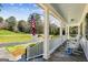 Inviting front porch with stone flooring, white columns, and rocking chairs at 1664 W Wesley Nw Rd, Atlanta, GA 30327