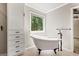 Elegant bathroom featuring a classic clawfoot tub, stylish fixtures, and ample natural light at 760 Swan Ln, Canton, GA 30115