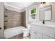Bathroom featuring a shower-tub combo and a white vanity at 760 Swan Ln, Canton, GA 30115