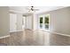 Light-filled bedroom with wood-look tile floors and access to the outside at 760 Swan Ln, Canton, GA 30115
