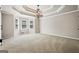 Expansive bedroom with trey ceiling, decorative chandelier, and abundant natural light from multiple windows at 760 Swan Ln, Canton, GA 30115