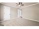 This bedroom features a neutral color palette, ceiling fan, and two white doors at 760 Swan Ln, Canton, GA 30115