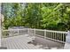 View from a spacious, gray painted deck with white railing, offering a view of the surrounding trees at 760 Swan Ln, Canton, GA 30115
