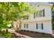 Exterior view of the home featuring a mix of traditional and modern architectural elements and mature trees at 760 Swan Ln, Canton, GA 30115