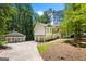 Charming home with a detached garage, lush landscaping, and a welcoming entrance at 760 Swan Ln, Canton, GA 30115