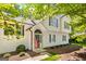 Two-story traditional home featuring white siding, black shutters, and a charming front porch with an arched entry at 760 Swan Ln, Canton, GA 30115
