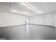 Spacious garage with white walls, gray floor, and two car door entries with natural light from a sky light at 760 Swan Ln, Canton, GA 30115