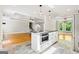 Kitchen island with oven and microwave is centrally located to living and dining areas at 760 Swan Ln, Canton, GA 30115
