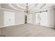 Large primary bedroom featuring trey ceiling, chandelier, and connecting bathroom and closet doors at 760 Swan Ln, Canton, GA 30115
