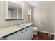 Classic bathroom featuring a sink vanity, toilet, and wood-look flooring at 261 Lakeview Dr, Locust Grove, GA 30248
