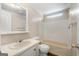 Standard bathroom with a vanity sink, toilet, and a bathtub with tiled walls at 261 Lakeview Dr, Locust Grove, GA 30248