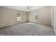 Bright bedroom featuring carpeted floors, a ceiling fan, and natural light through the windows at 261 Lakeview Dr, Locust Grove, GA 30248