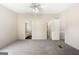 This carpeted bedroom offers a doorway to an en-suite bathroom and closet at 261 Lakeview Dr, Locust Grove, GA 30248