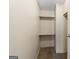 A walk-in closet featuring carpeted floors and shelving, offering ample storage space at 261 Lakeview Dr, Locust Grove, GA 30248