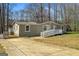 Charming single-story home with a well-maintained lawn and a ramp leading to the front entrance at 261 Lakeview Dr, Locust Grove, GA 30248