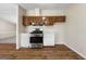 Well-equipped kitchen with a modern gas range and oven, paired with sleek white cabinetry and stylish flooring at 261 Lakeview Dr, Locust Grove, GA 30248