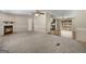 Spacious living room featuring a fireplace and plush carpeting flowing seamlessly to the adjacent area at 261 Lakeview Dr, Locust Grove, GA 30248