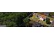 An aerial view showcases a property with a pool and gazebo with mature trees in a vibrant neighborhood at 227 River Trace Ct, Mcdonough, GA 30253