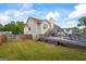 Well-maintained backyard with a wooden fence, swimming pool, deck, and home exterior at 227 River Trace Ct, Mcdonough, GA 30253