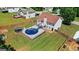 A large backyard with a deck featuring an above-ground pool with slide, a gazebo and fenced yard at 227 River Trace Ct, Mcdonough, GA 30253