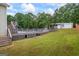 Spacious backyard featuring an inground pool, expansive deck, and detached garage at 227 River Trace Ct, Mcdonough, GA 30253
