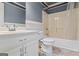 Bathroom featuring a bathtub and shower combination, a white vanity, and an octagon-shaped window at 227 River Trace Ct, Mcdonough, GA 30253