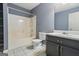 Functional bathroom with a tub-shower combo, toilet, and vanity with gray cabinetry at 227 River Trace Ct, Mcdonough, GA 30253