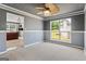 Spacious bedroom features neutral carpet, gray walls, white trim, and a ceiling fan with light fixture at 227 River Trace Ct, Mcdonough, GA 30253