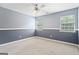 Bedroom features neutral carpet, two-tone blue walls, white trim, and two windows with natural light at 227 River Trace Ct, Mcdonough, GA 30253
