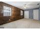 Inviting bedroom with a rustic wood accent wall, bright windows, and ample closet space at 227 River Trace Ct, Mcdonough, GA 30253