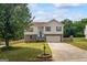 Charming two-story home with well-maintained lawn, stone accents, and inviting curb appeal at 227 River Trace Ct, Mcdonough, GA 30253