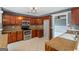 Well-lit kitchen featuring wood cabinets, stainless steel appliances, and tile flooring at 227 River Trace Ct, Mcdonough, GA 30253